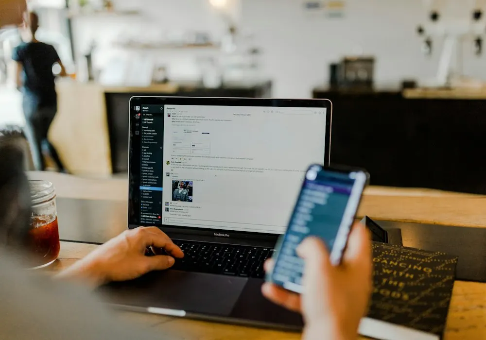 A developer reviewing software on a laptop and phone